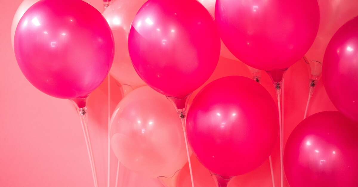 pink balloons against a pink wall.