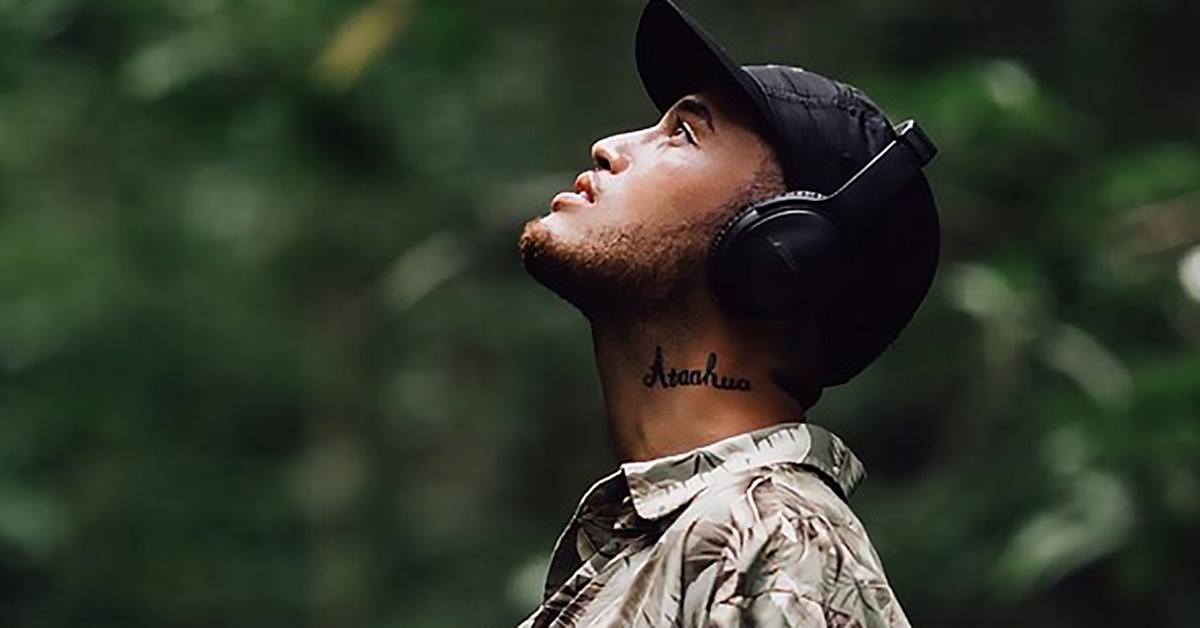 Stan Walker Wearing headphones looking upwards